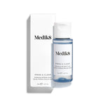 Medik8 Press & Glow tonic bottle stands in front of its matching white product carton on a clean white background. Text on both identifies the product as a travel sized Daily Exfoliating PHA Tonic with Enzyme Activator. 