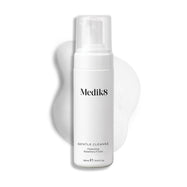 A Medik8 Gentle Cleanse pump bottle displayed on a white background with a smear of white foam behind it, highlighting the product's hydrating texture.