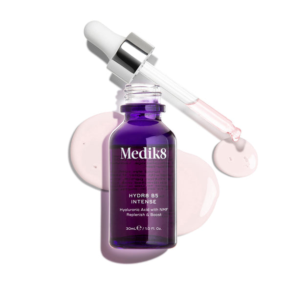 Medik8 Hydr8 B5 Intense glass dropper bottle in deep purple, shown with an open pipette resting above light pink serum droplets on a clean white background. Text highlights the formula as Hyaluronic Acid with NMF (Natural Moisturising Factors) to Replenish & Boost in a 30mL size.-1