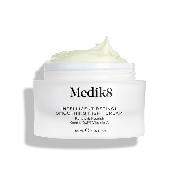 A shot of the Intelligent Retinol Smoothing Night Cream jar, open and showing the cream, on a white background. -7