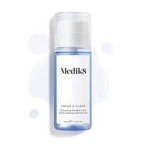 Medik8 Press & Clear bottle (150ml) displayed on a white background with splashes of blue tonic around it. Text highlights the  Exfoliating 2% BHA Tonic  formula.