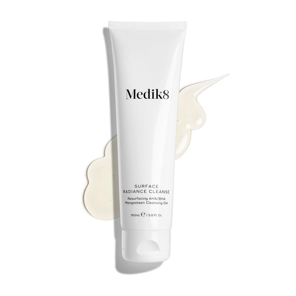 Medik8 Surface Radiance Cleanse tube displayed on a clean white background with a large, translucent gel texture smear. Text identifies it as a Resurfacing AHA/BHA Mangosteen Cleansing Gel in a 150mL size.-3