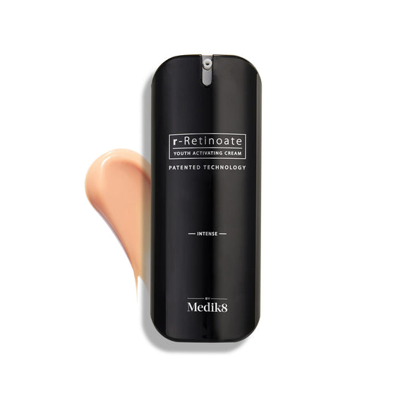 Medik8 r-Retinoate Intense Youth Activating Cream bottle displayed on a white background with a swatch of the peach-toned cream texture visible behind it.-8