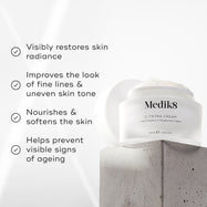 "Medik8 C-Tetra Cream jar displayed on a grey stone block against a white background with soft light rays. The image features four check-marked claims:

Visibly restores skin radiance

Improves the look of fine lines & uneven skin tone

Nourishes & softens the skin

Helps prevent visible signs of ageing"