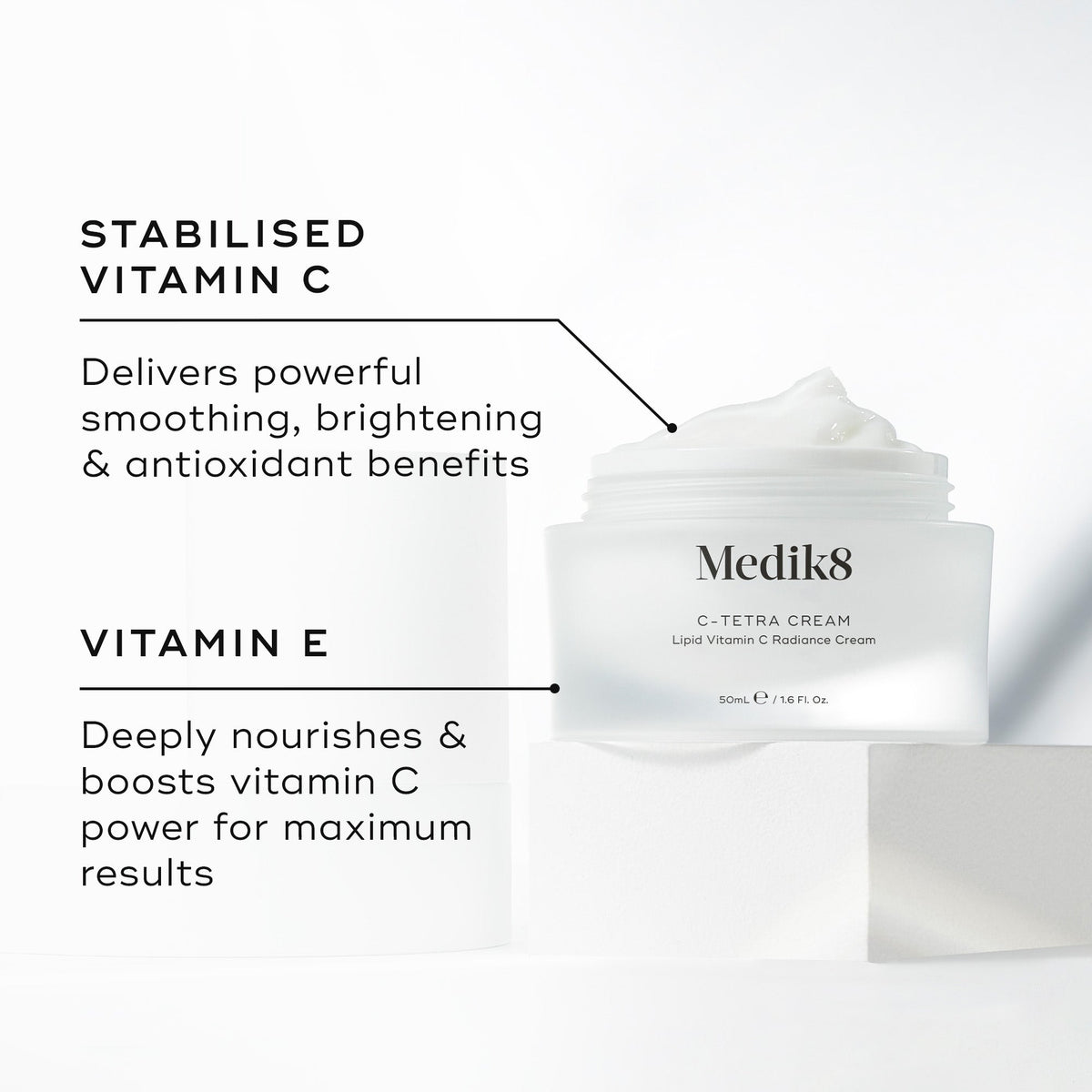 Medik8 C-Tetra Cream jar displayed open on a white stone block against a clean white background. The image features two key ingredients and their benefits:

STABILISED VITAMIN C: Delivers powerful smoothing, brightening, and antioxidant benefits.

VITAMIN E: Deeply nourishes and boosts vitamin C power for maximum results.