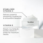 "Medik8 C-Tetra Cream jar displayed open on a white stone block against a clean white background. The image features two key ingredients and their benefits:

STABILISED VITAMIN C: Delivers powerful smoothing, brightening, and antioxidant benefits.

VITAMIN E: Deeply nourishes and boosts vitamin C power for maximum results."