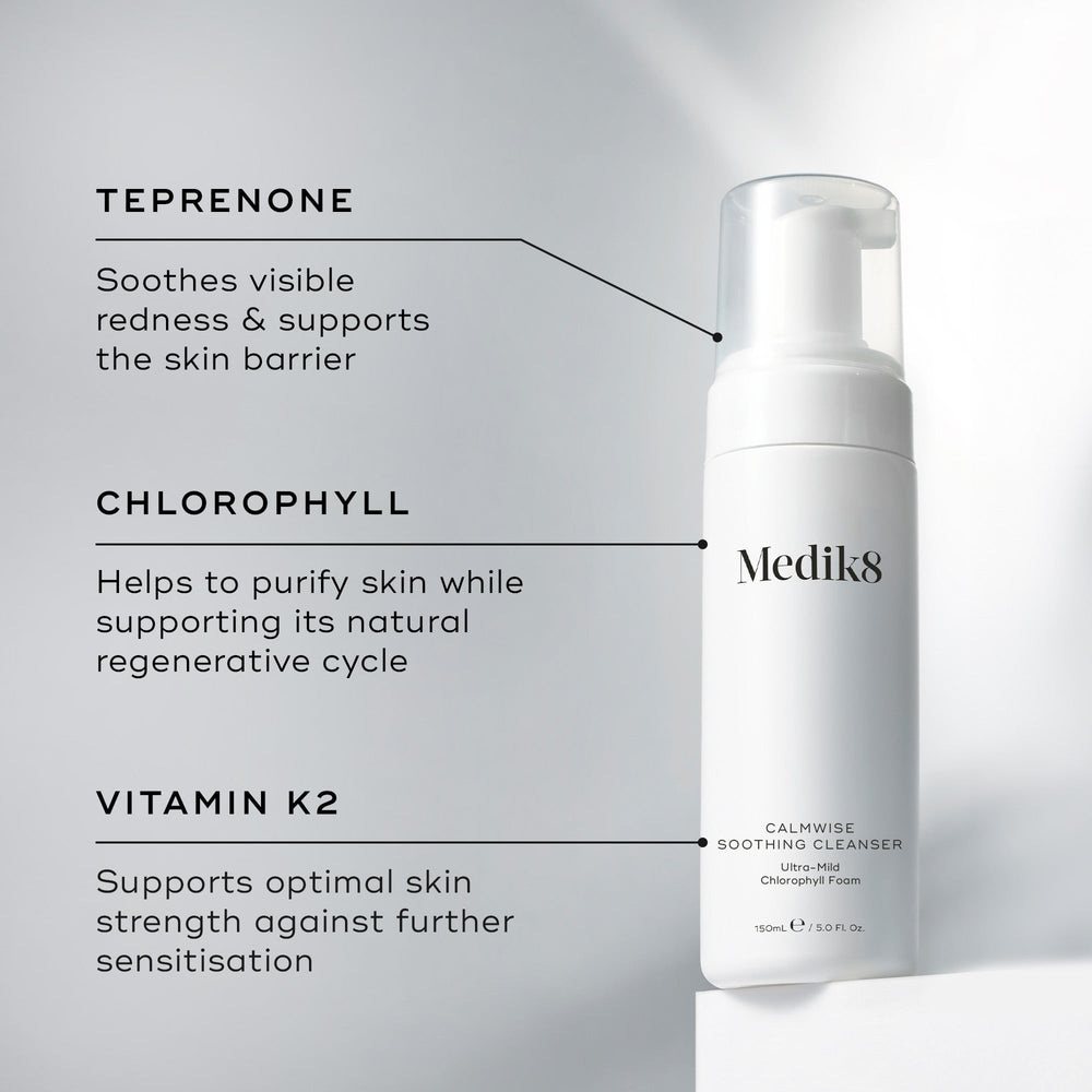 A Medik8 Calmwise Soothing Cleanser bottle displayed on a white block. Lines connect the bottle to text explaining key ingredients:  Teprenone  to soothe redness,  Chlorophyll  to purify skin, and  Vitamin K2  to support skin strength.