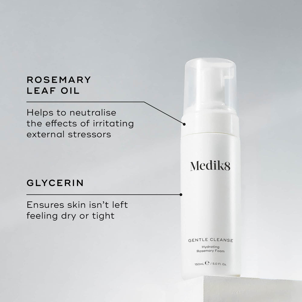 A Medik8 Gentle Cleanse bottle displayed on a white block. Lines connect the bottle to text explaining key ingredients: "Rosemary Leaf Oil" to neutralise the effects of irritating external stressors and "Glycerin" to ensure skin isn't left feeling dry or tight.
