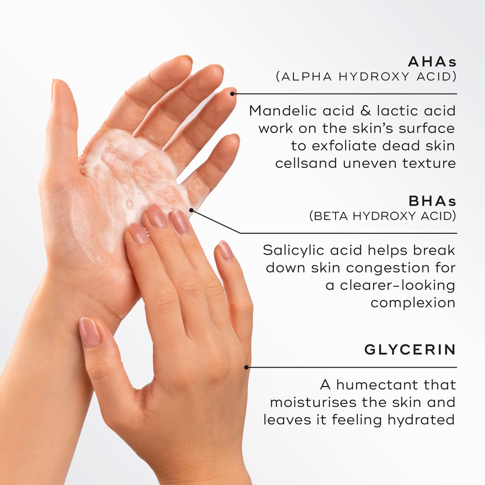 Close-up of hands lathering a light foam, highlighting key ingredients for Medik8 Surface Radiance Cleanse. Text describes AHAs (Mandelic and Lactic acid) for surface exfoliation, BHAs (Salicylic acid) to break down congestion, and Glycerin to moisturise and hydrate.