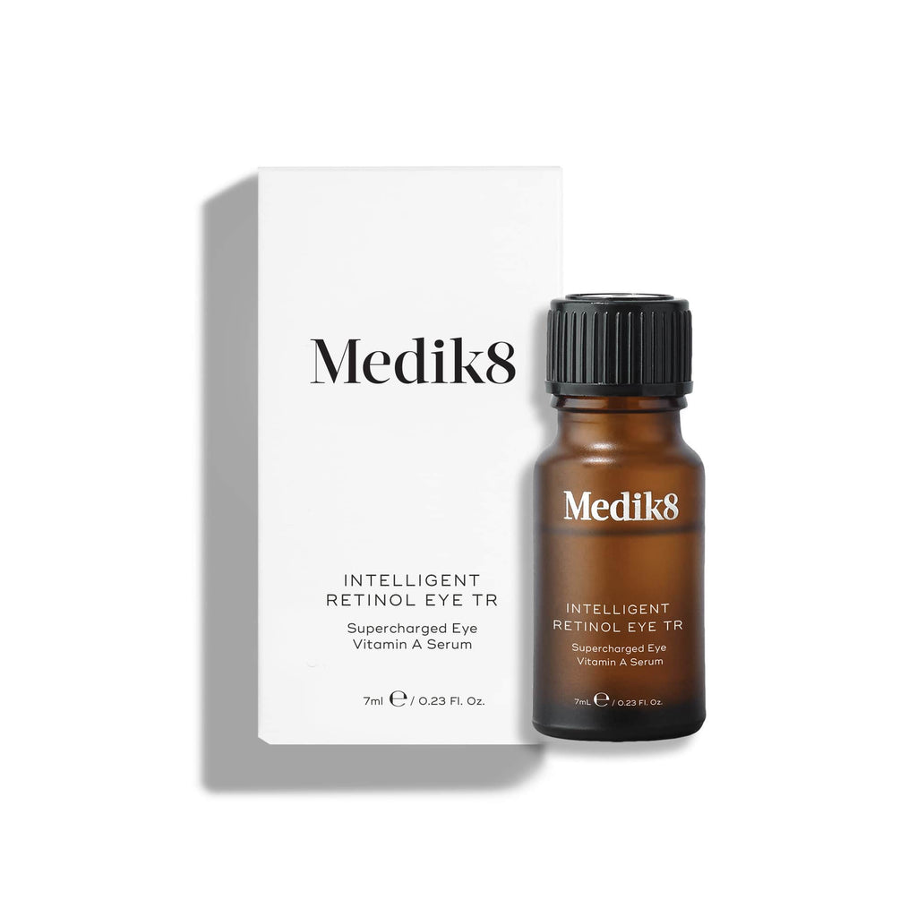 A small amber Intelligent Retinol Eye TR serum bottle stands in front of a white carton.