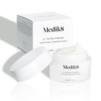 Medik8 C-Tetra Cream jar and its white cardboard carton displayed on a clean white background with soft shadows. The open white, frosted-glass jar features the Medik8 logo and is labeled  C-TETRA CREAM Lipid Vitamin C Radiance Cream  in a 50mL size. A thick swirl of white cream is visible on top of the jar, with the white box behind it showing the product name and a partial ingredients list.
