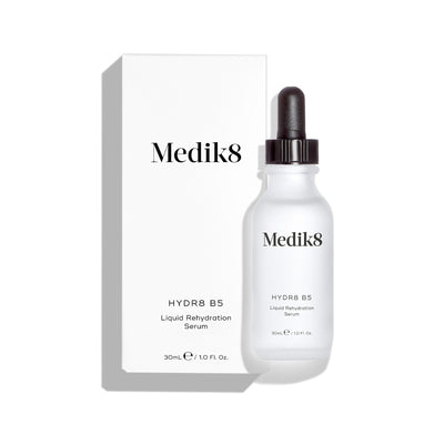 Medik8 Hydr8 B5 serum bottle stands in front of its matching white product carton on a clean white background. Text on both identifies the product as a 30mL  Liquid Rehydration Serum. 