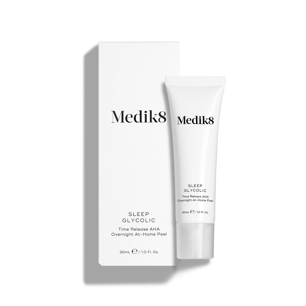 Medik8 Sleep Glycolic tube stands in front of its matching white product carton on a clean white background. Text on both the tube and box identifies the product as a 30mL  Time Release AHA Overnight At-Home Peel. 