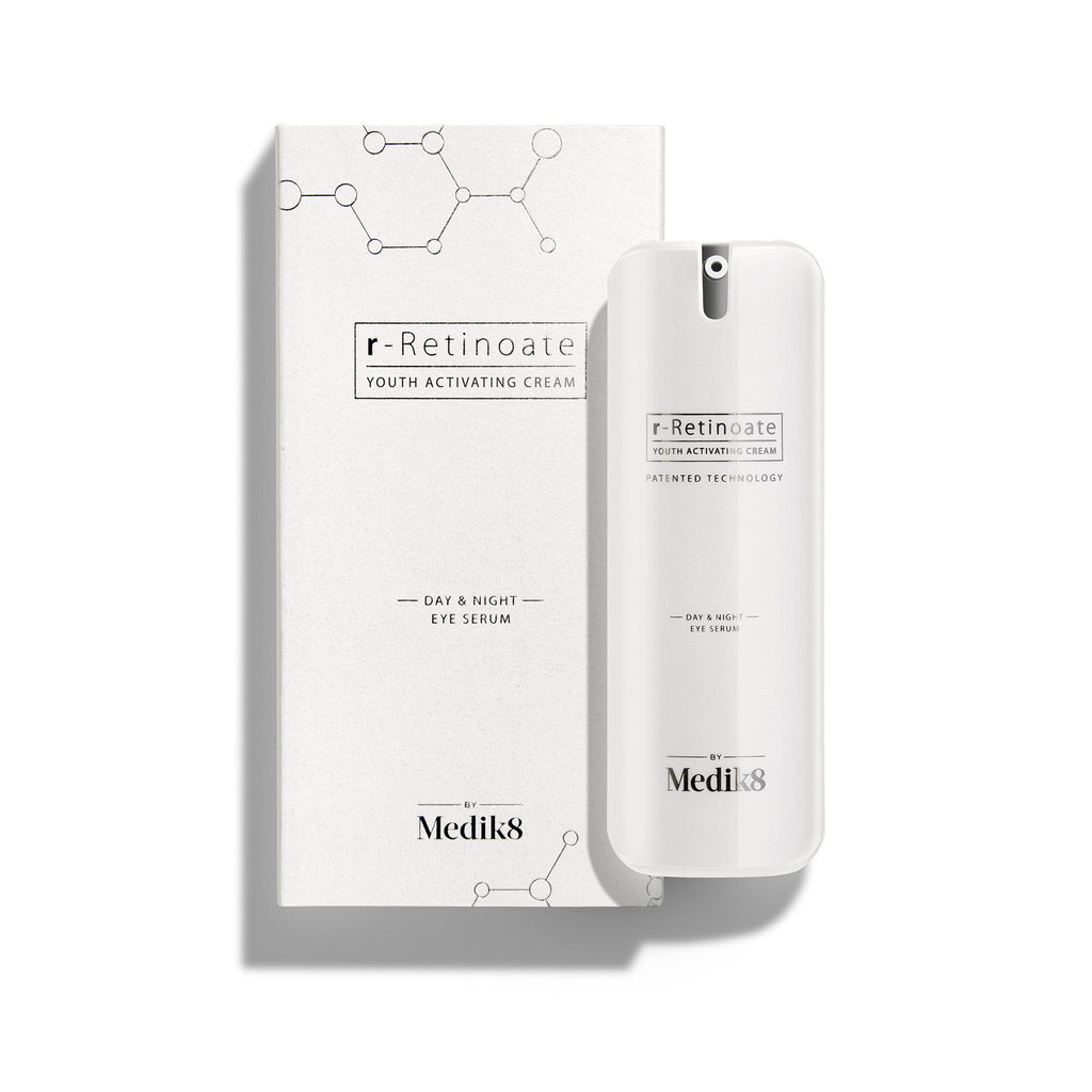 A white pump bottle of r-Retinoate Day & Night Eye Serum stands beside its matching white carton. 