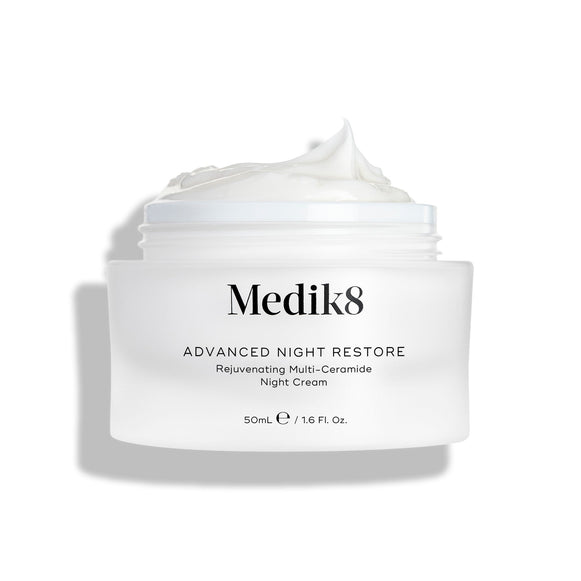Medik8 Advanced Night Restore cream jar shown open with a rich dollop of white cream peaked on top against a clean white background, highlighting its smooth, restorative texture. Black text on the jar reads  Rejuvenating Multi-Ceramide Night Cream .-2