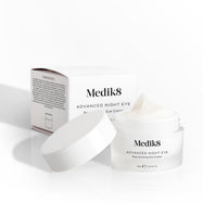Medik8 Advanced Night Eye cream jar sits open next to its packaging box on a white background. Text highlights the  Rejuvenating Eye Cream  formula and 15mL size.
