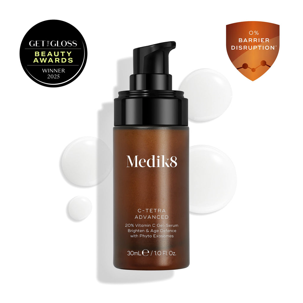 Medik8 C-Tetra Advanced bottle displayed on a clean white background with translucent serum droplets, highlighting its lightweight gel-serum texture.