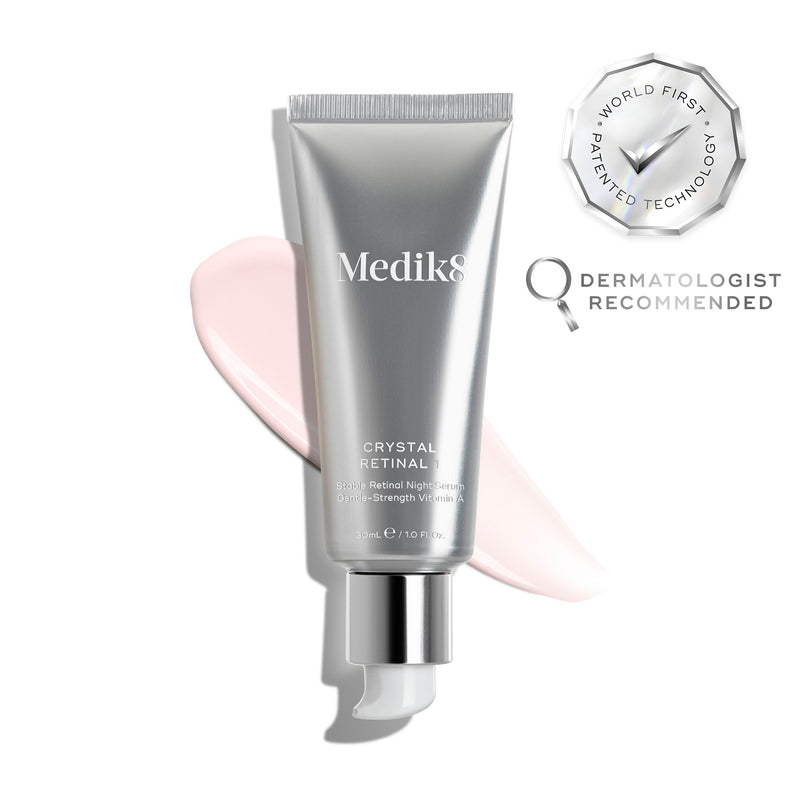 A silver tube of Crystal Retinal 1 is displayed, with a pink cream swatch to its right. A WORLD FIRST PATENTED TECHNOLOGY seal and a DERMATOLOGIST RECOMMENDED icon are shown. 