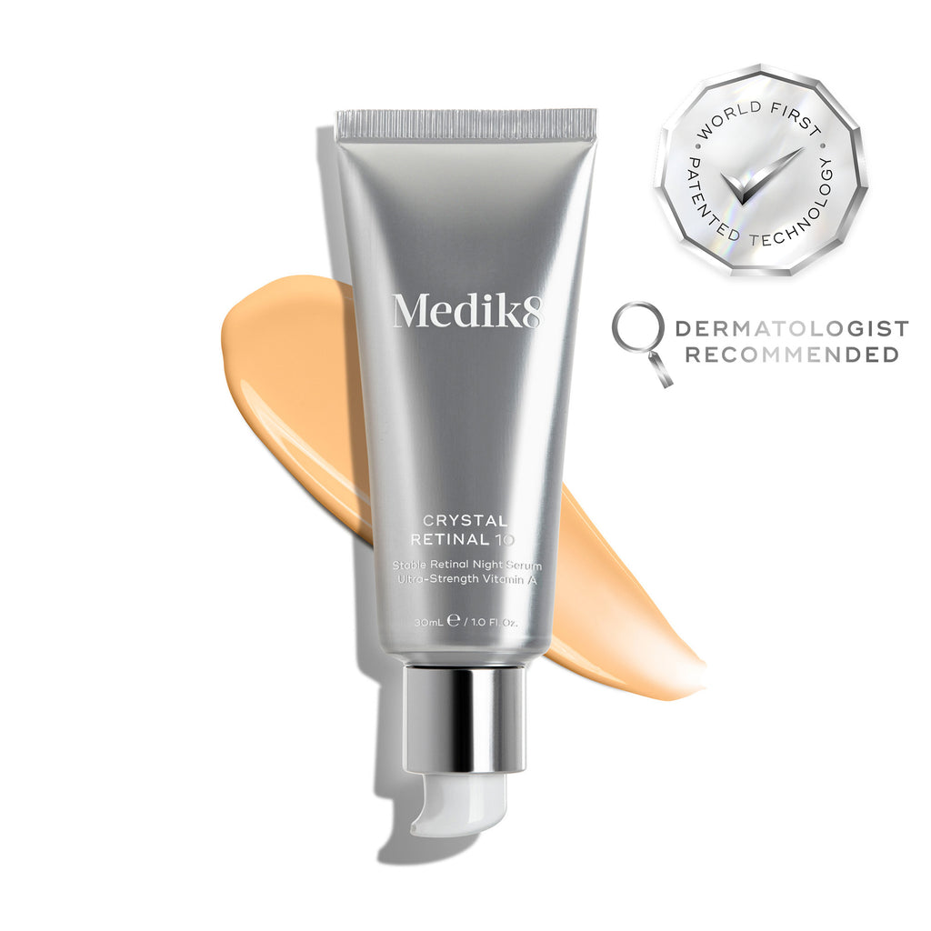 A silver tube of Crystal Retinal 10 is displayed, with an orange swatch. A WORLD FIRST PATENTED TECHNOLOGY seal and a DERMATOLOGIST RECOMMENDED icon are shown. 